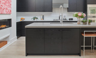 Kitchen with fireplace and island with concrete countertops.