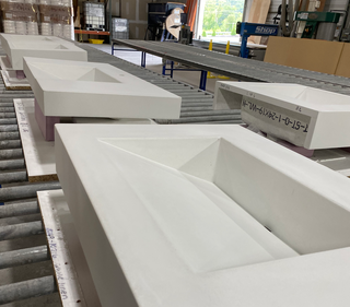 Unfinished white concrete ramp sinks in the factory.