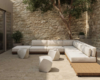 Secluded outdoor patio with small concrete tables.