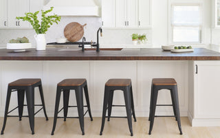 Wood look concrete countertop in a bright white kitchen with dark-tone wood accents.