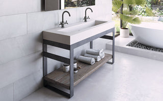 Double faucet rectangular concrete sink with black steel base and open wood shelf, styled in a warm modern bathroom—ideal for residential master baths, boutique hotels, and designer remodels