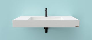 Sleek wall-mounted rectangular white concrete sink with integrated basin and matte black faucet, set against a pastel blue backdrop—ideal for modern commercial restrooms, hospitality, and minimalist residential spaces